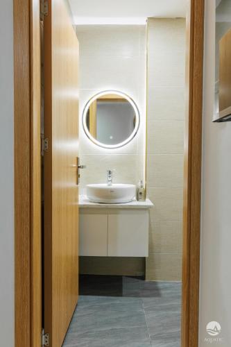 a bathroom with a sink and a mirror at Aquatic Hotel Cat Ba in Cat Ba