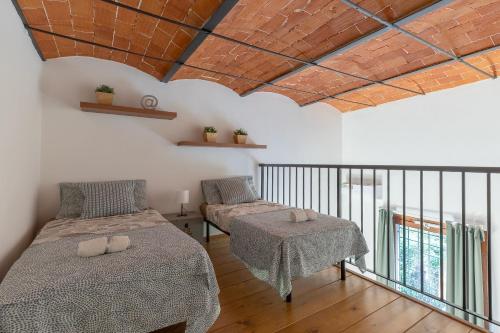 a bedroom with two beds and a balcony at Colonica San Cresci alle porte di Firenze 6 pax free parking in Campi Bisenzio