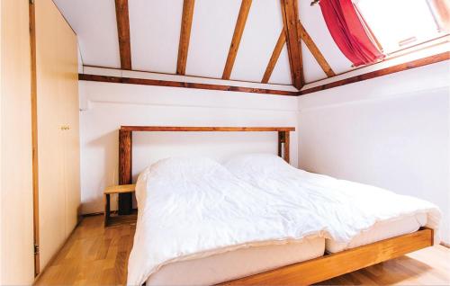 an attic bedroom with a bed with white sheets at Ferienhaus 22 In Frankenau in Frankenau
