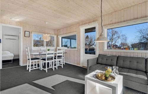 a living room with a couch and a table at Four-Bedroom Holiday Home In Juelsminde in Sønderby