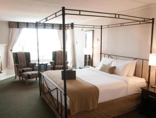 a bedroom with a large bed with a metal frame at Coast High Country Inn in Whitehorse