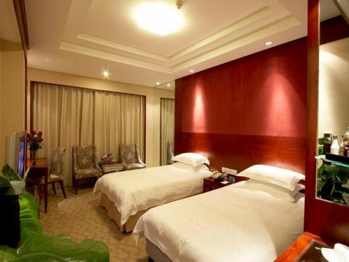 a hotel room with two beds and a room with at Huachen Kenzo Hotel Hangzhou in Hangzhou