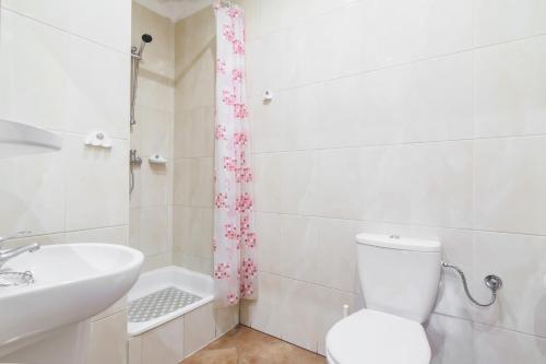 a bathroom with a toilet and a sink and a tub at Posejdon Wydmowa 16 3 in Lubiatowo