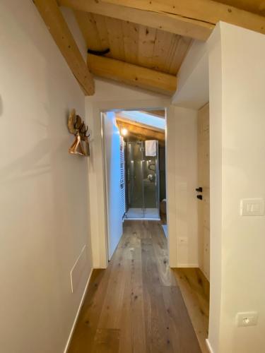 a hallway with white walls and wooden ceilings at Pedegagia in Vezzano