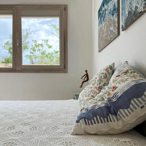 a bedroom with a bed with a pillow and a window at Agriturismo Spirdo in Ruffano