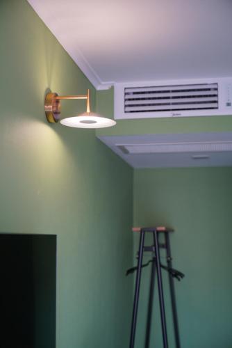 a light on the ceiling of a room with a fan at Station 22 Hotel in Batumi