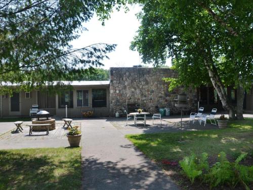 a patio with tables and chairs in front of a building at Birchwood Inn in Harbor Springs