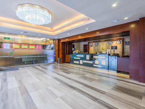 a large room with a dance floor and a chandelier at Movie Star Hotel in Guangzhou