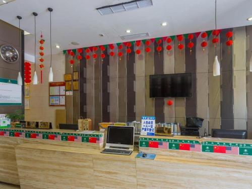 a restaurant counter with a laptop on top of it at GreenTree Alliance Shenzhen Shekou Sea World Hotel in Shenzhen