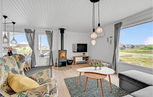 a living room with a couch and a table at Holiday Home Hvide Sande 31 in Bjerregård