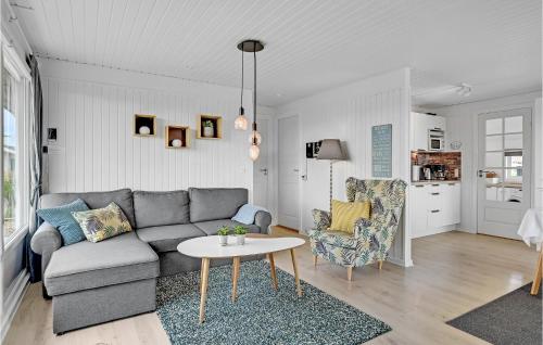 a living room with a couch and a table at Holiday Home Hvide Sande 31 in Bjerregård