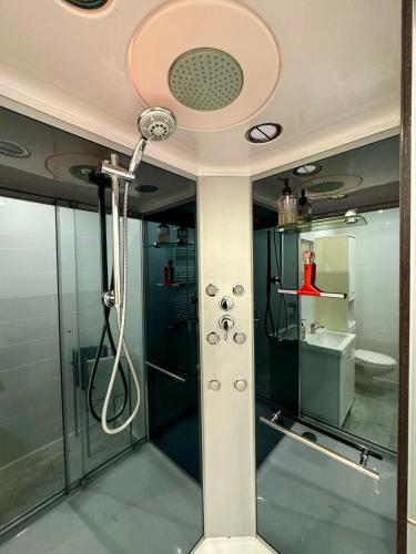 a bathroom with a shower and a sink at Villa Blue Sky in Heinkensand