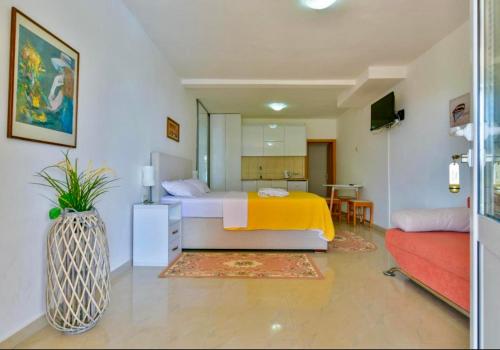 a bedroom with a bed and a vase at Apartments Kentera LUX in Sveti Stefan