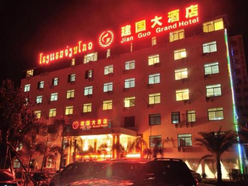 a hotel with neon signs on the side of it at Jian Guo Grand Hotel in Vientiane