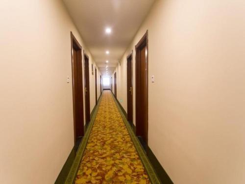 an empty hallway with a floor covered in leaves at GreenTree Inn Suzhou Guanqian Street Leqiao Metro Station in Suzhou