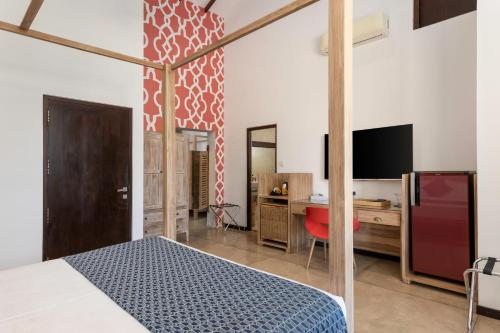 a bedroom with a bed and a desk and a tv at Parangi Weligama Bay - Thema Collection in Weligama