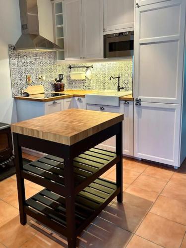 a kitchen with a table in the middle of it at The Gables Cottage in Rathvilly