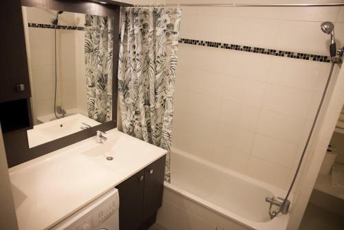 a bathroom with a sink and a tub and a shower at OIQIA • Séquoia in LʼUnion