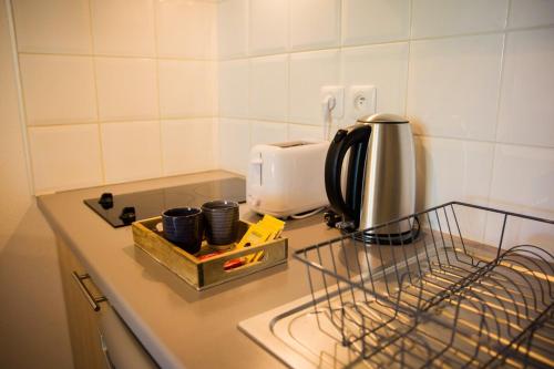 a kitchen counter with a coffee maker and a toaster at OIQIA • Séquoia in LʼUnion
