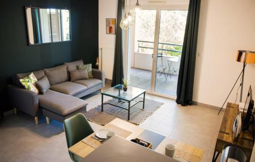 a living room with a couch and a table at OIQIA • Séquoia in LʼUnion
