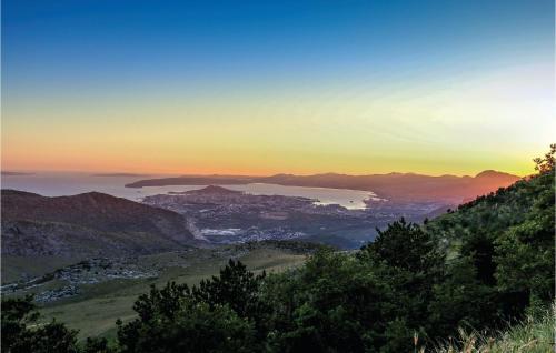 a view of a city and the ocean at sunset at Cozy Home In Srinjine in Srinjine