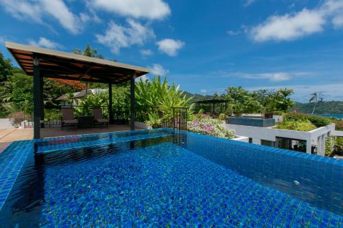 a swimming pool in the middle of a villa at Kata Gardens Penthouse sea view 4C near Kata Noi Beach in Kata Beach