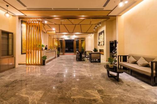 a lobby with a couch and chairs in a building at Chambery Hotel in Zhuhai