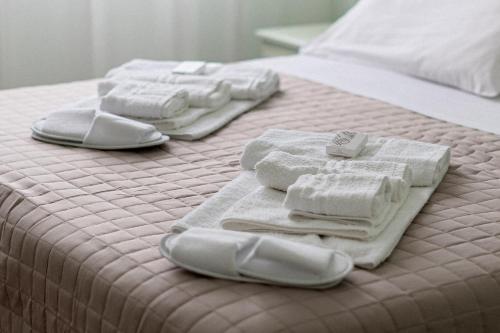 three towels are sitting on top of a bed at Hotel Oberdan Ristorante Pizzeria in Concordia Sagittaria