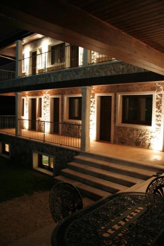 a building with a porch and stairs at night at A Maquia in Poio