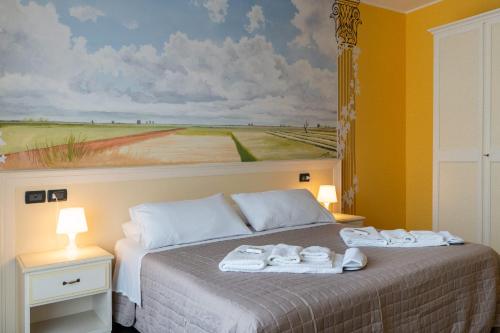 a bedroom with a bed with towels on it at Hotel Oberdan Ristorante Pizzeria in Concordia Sagittaria