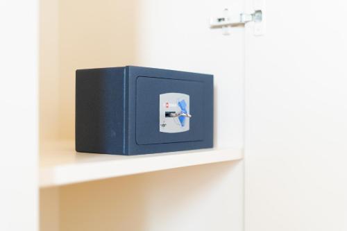 a blue electrical box sitting on a shelf at Hotel Oberdan Ristorante Pizzeria in Concordia Sagittaria