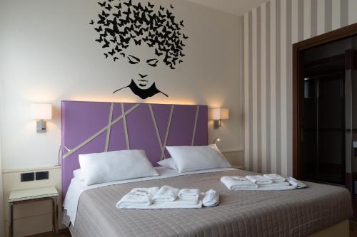 a bedroom with a bed with towels on it at Hotel Oberdan Ristorante Pizzeria in Concordia Sagittaria