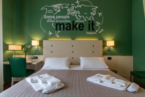 a bedroom with a bed with towels on it at Hotel Oberdan Ristorante Pizzeria in Concordia Sagittaria