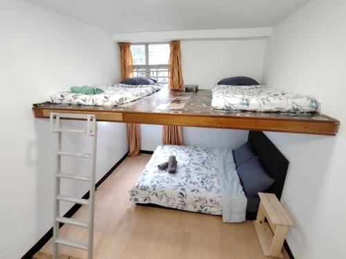 two bunk beds in a room with a ladder at Venice Hill Cheras Young Forever Homestay in Cheras