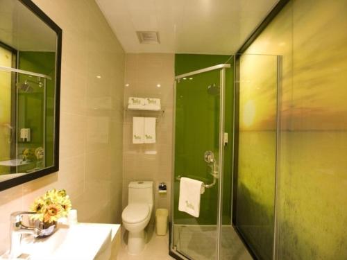 a bathroom with a shower and a toilet and a sink at Vatica Beijing Tongzhou Liyuan Universal Studios in Beijing