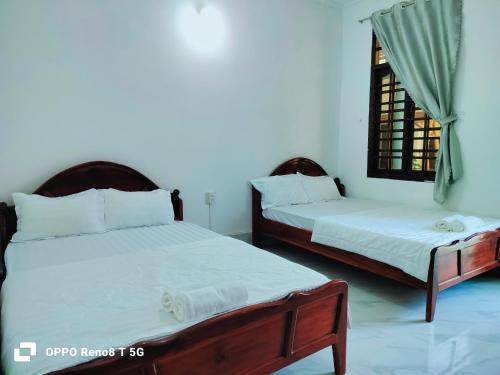 En eller flere senge i et værelse på DIỆP NGỌC MAI Guest House