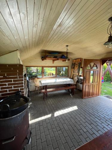 a large room with a bed and a fireplace in a house at Chata Nikol in Oravská Lesná