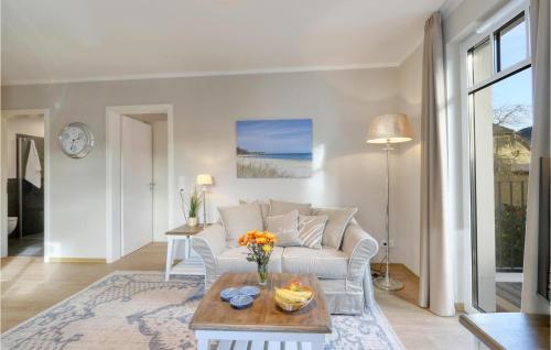 a living room with a couch and a table at Baltischer Hof Apartment 27 in Boltenhagen