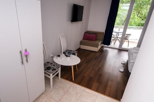 a living room with a table and chairs and a couch at Nature View in Mostar