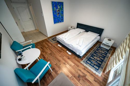 a bedroom with a bed and a table and chairs at Nature View in Mostar