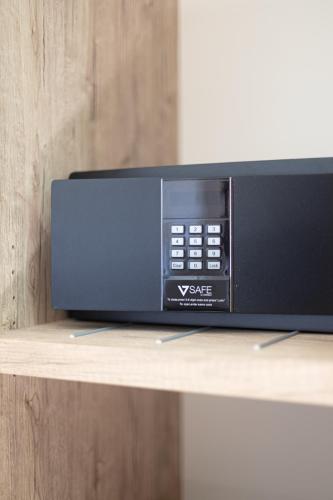a microwave oven sitting on top of a shelf at Hotel Tornielli 9 by LVG Hotel Collection in Novara