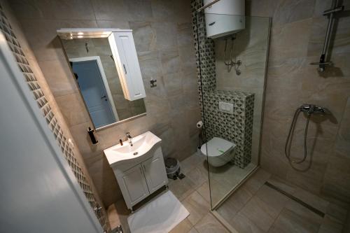 a bathroom with a sink and a toilet and a mirror at Nature View in Mostar