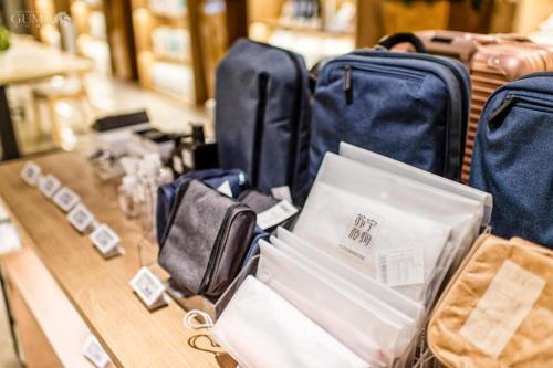 a pile of luggage sitting on top of a table at AURAYA BY SUNING NANJING XUZHUANG in Nanjing