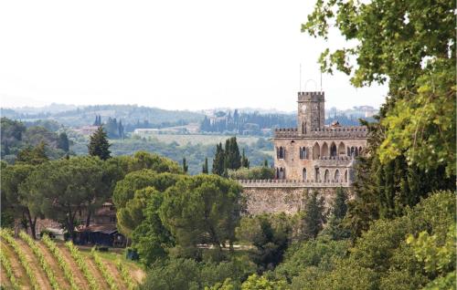 a castle in the middle of a field with trees at Sanlucchese 3 in Poggibonsi
