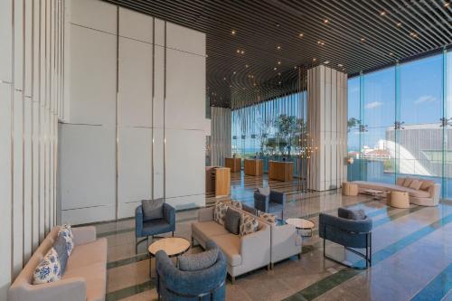 a lobby with couches and chairs in a building at Akara Hotel Pattaya in Pattaya North