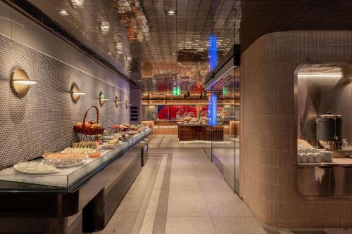 a bakery with a buffet of food on display at Akara Hotel Pattaya in Pattaya North