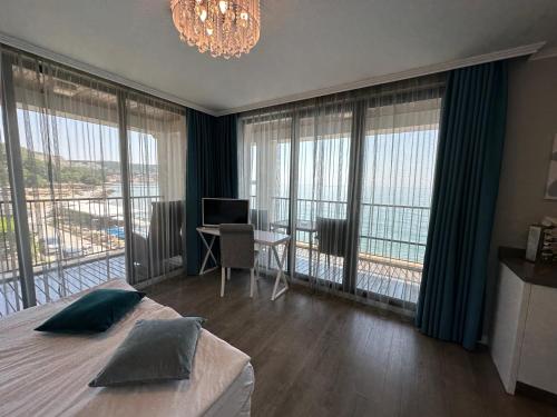 a bedroom with a bed and a desk with a computer at Regina Maria Spa Design Hotel in Balchik
