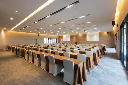 a large room with rows of tables and chairs at GRACE Select Hotel (Kunshan Huaqiao International Convention Center) in Suzhou