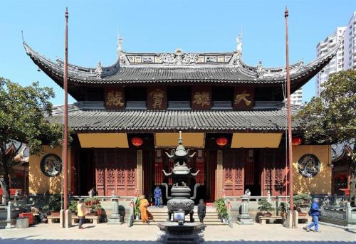 a large building with a statue in front of it at YUNIK-Shanghai Zhongshan Park Yan'an Xi Road in Shanghai