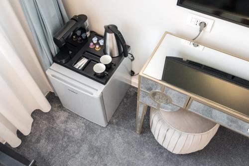 a room with a desk and a sewing machine at HIGHLINE DOWNTOWN ApartHotel OLDTOWN UNIRII SQUARE in Bucharest